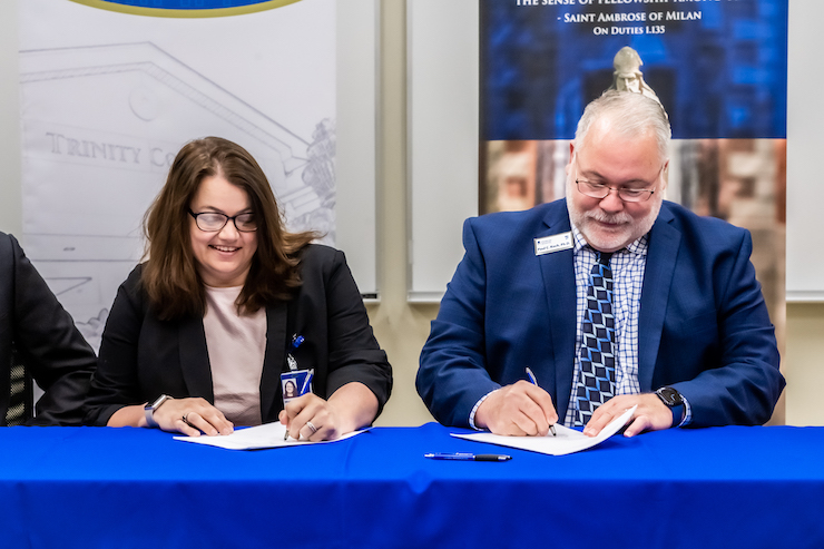 SAU Provost Paul Koch and a representative from Trinity College of Nursing sign the agreement on Thursday, June 8. 